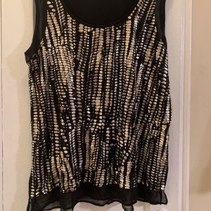 Lightweight black knit with metallic print. Sheer black trim at slvs and hem.